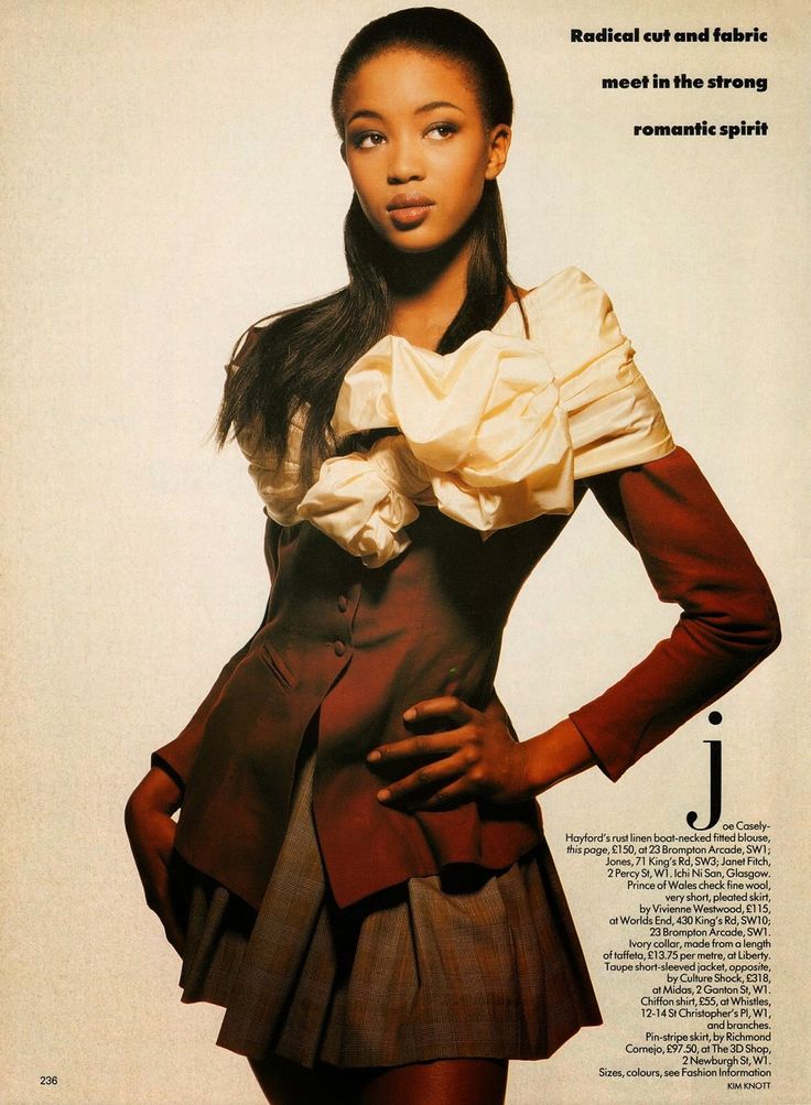 a woman in a skirt and jacket posing for a magazine