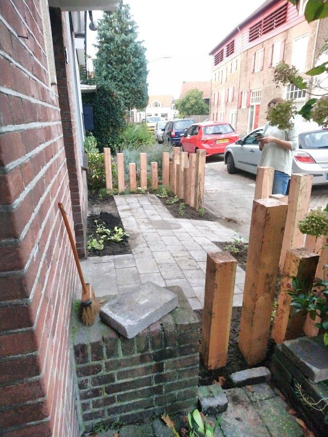 a brick walkway leading to a parking lot