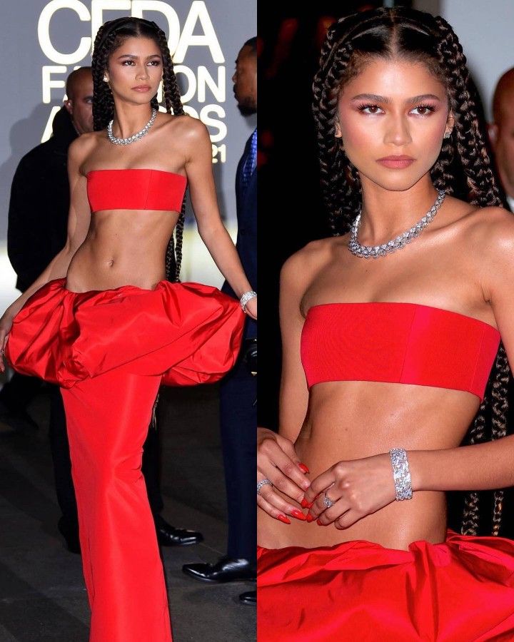 an image of a woman in a red dress with her hands on her hips and wearing jewelry