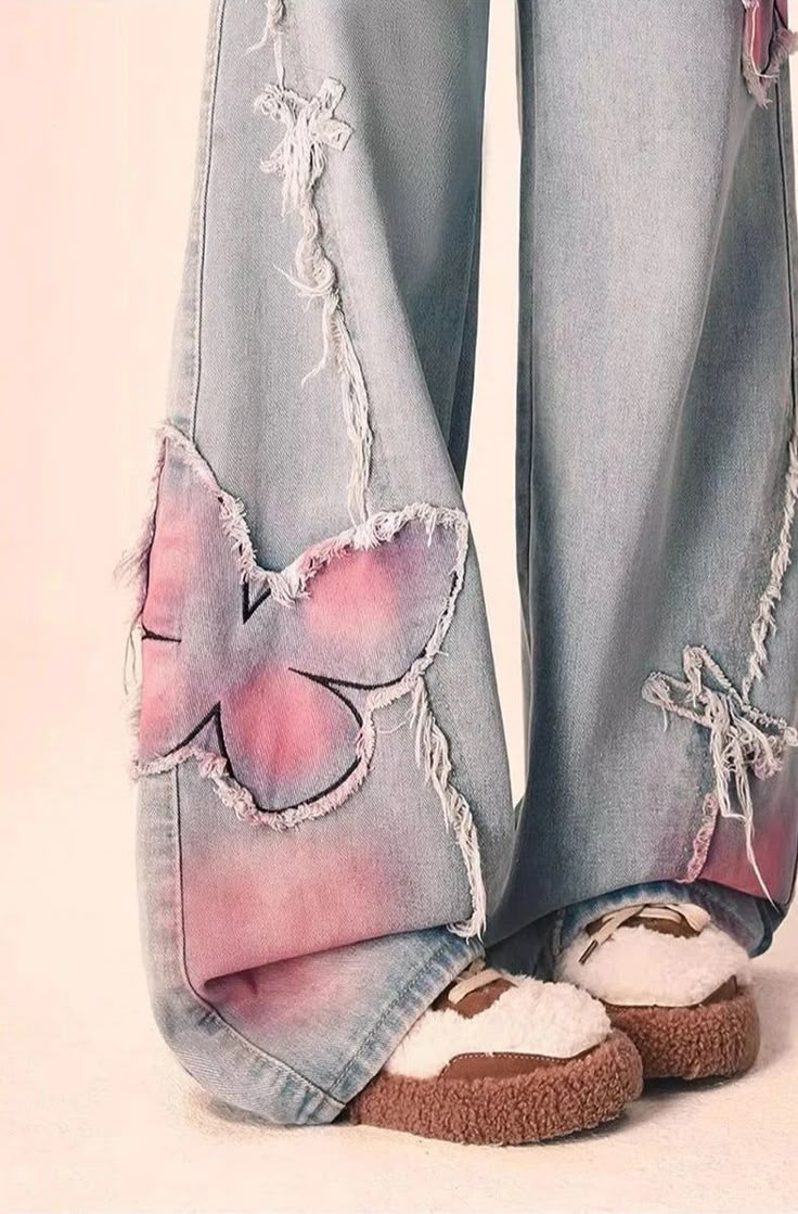 Rock these Distressed Pink Butterfly Jeans 🦋 and make a statement with their unique distressed design. These cute and pretty jeans feature edgy pink butterfly designs that will surely turn heads. Be bold and playful with your fashion choice! Size Chart: Size Waist (cm) Hip (cm) Length (cm) Waist (in) Hip (in) Length (in) S 63 94 100 24.80 37.01 39.37 M 67 98 101 26.38 38.58 39.76 L 71 102 102 27.95 40.16 40.16 XL 75 106 103 29.53 41.73 40.55 Description: Item Type: JeansJeans Style: High Waist Wide Leg PantsClosure Type: Zipper FlyMaterial: Cotton/LinenElasticity: Slight StretchLength: Full LengthFit Type: LooseDecoration: EmbroideryOrigin: CN Thickness: Regular Jeans With Patterns, Artsy Jeans, Patchy Jeans, Jeans With Hearts, Pink And Blue Outfit, Pink Jeans Outfit, Paint Pants, Butterfly Clothing, Funky Jeans