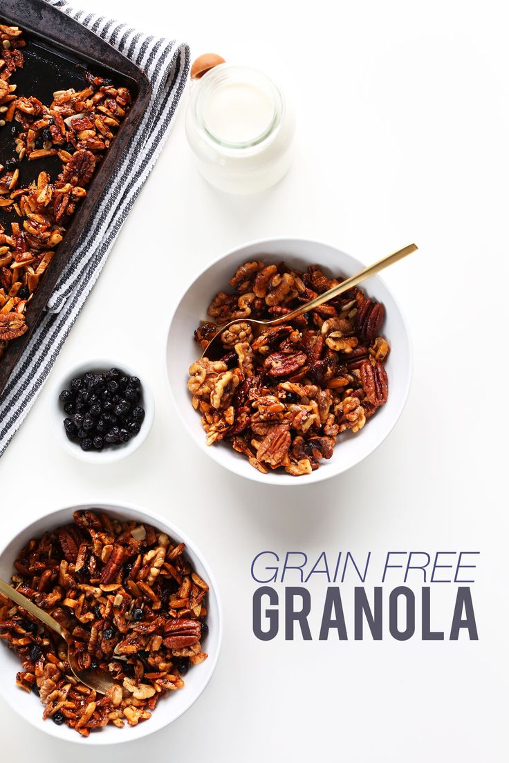 granola in white bowls with blueberries and yogurt