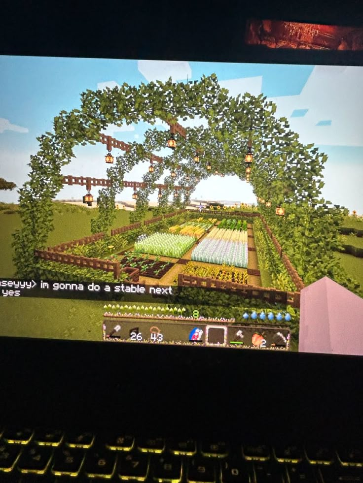 a computer screen showing an image of a farm in the middle of trees and flowers