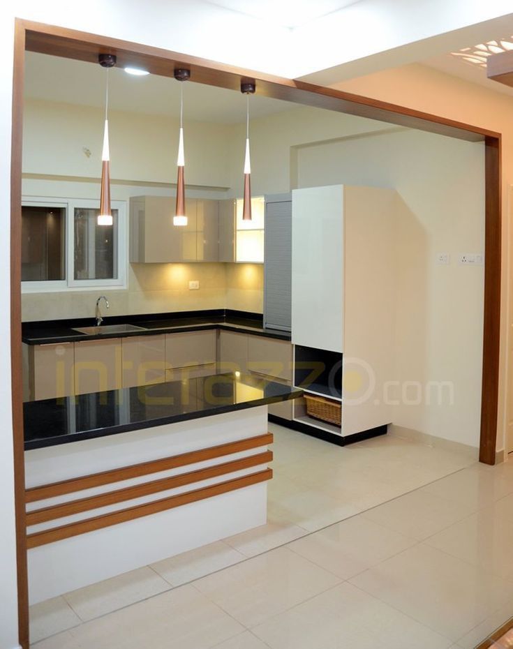 an empty kitchen with white cabinets and black counter tops in a house or office space