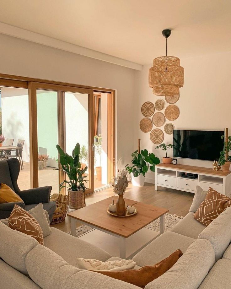 a living room filled with furniture and a flat screen tv sitting on top of a wooden table