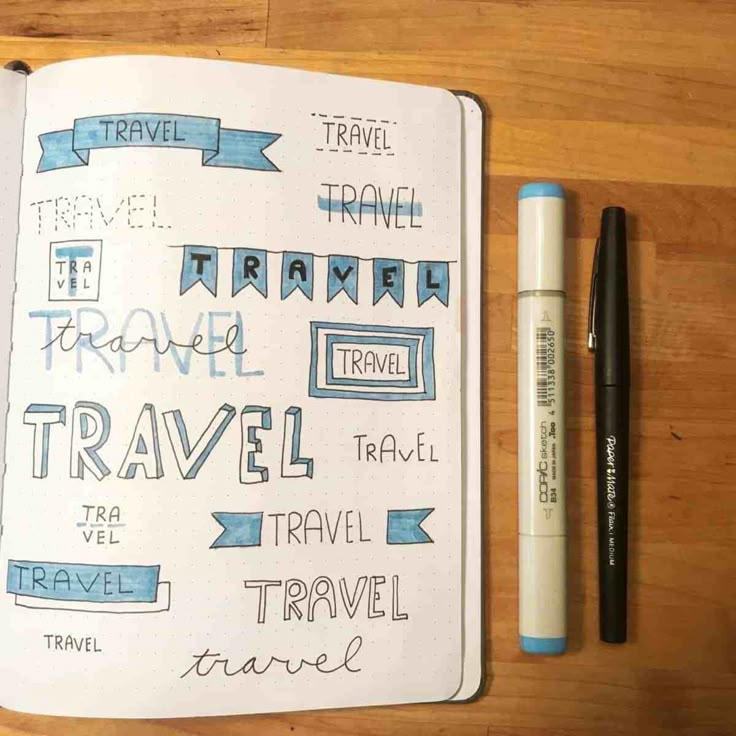 an open notebook with travel related items on it next to a fountain pen and marker