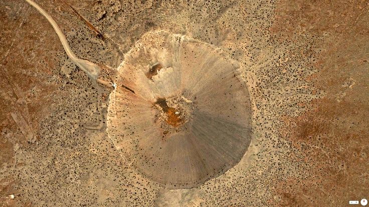 an aerial view of a tree stump in the desert