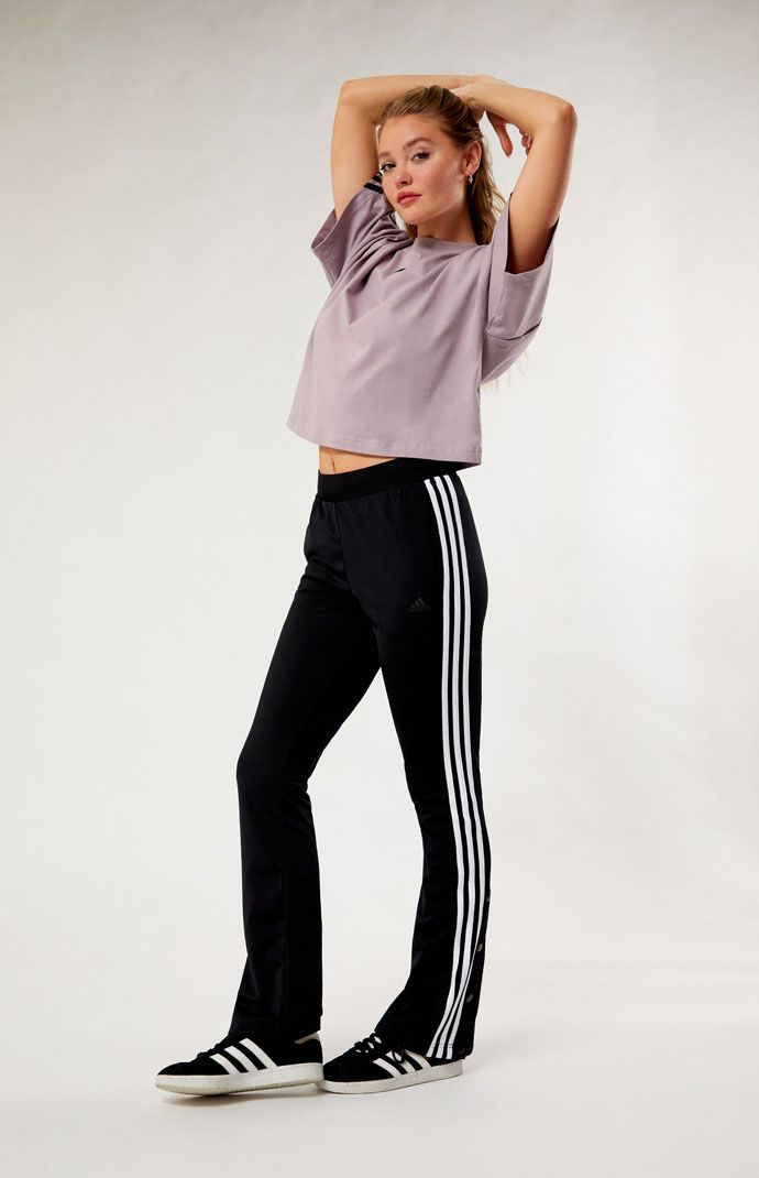 Step into athletic-inspired style with the Black Quarter Snap Tricot Track Pants from adidas. Featuring a sleek design with quarter snap closures down the sides, these track pants offer a perfect blend of sporty flair and casual comfort. 


	Solid color track pants
	31" inseam
	11.75" rise
	High-rise
	Interior drawstring waistband
	3-Stripes
	Quarter snap-buttons
	adidas embroidery
	100% recycled polyester
	Machine washable
	Model is wearing a size small
	Model measurements: 5&rsq Adidas Embroidery, Fall Festival Outfit, Track Pants Outfit, Italian Summer Outfits, Spring Outfits Dresses, Track Pants Women, Italian Dress, Adidas Track Pants, Adidas Womens