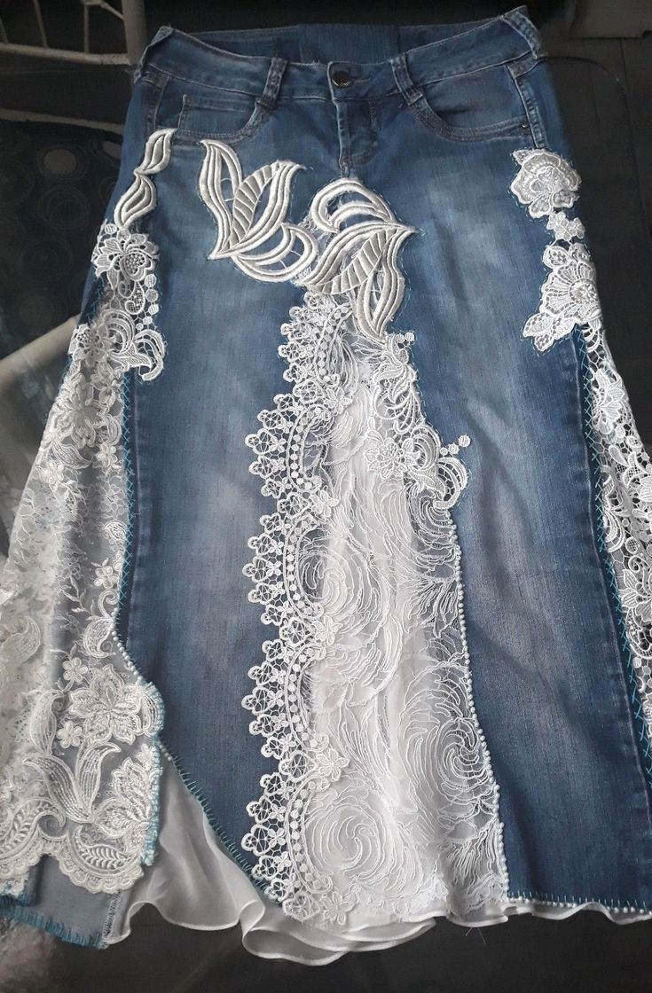 a pair of jeans with white lace on the bottom and blue denim skirt underneath it