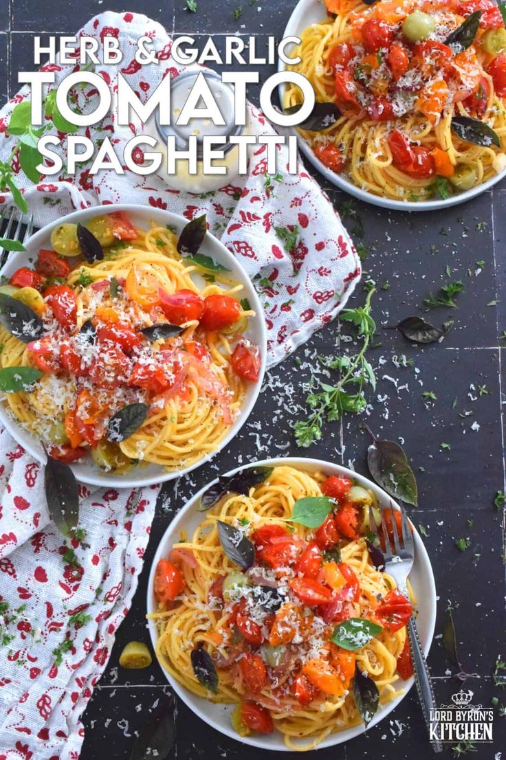 two plates of spaghetti with tomato sauce and parmesan cheese on the side, topped with basil leaves