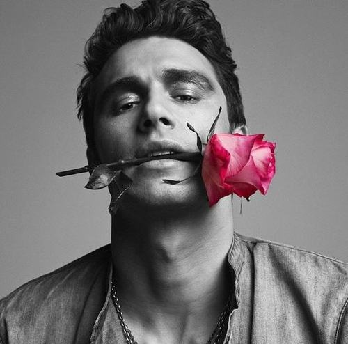 a man with a rose in his mouth