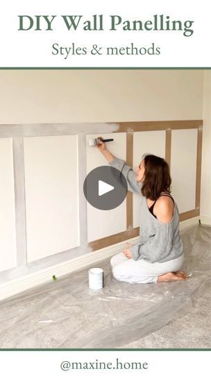 a woman is painting the walls in her living room with white paint and she is sitting on the floor