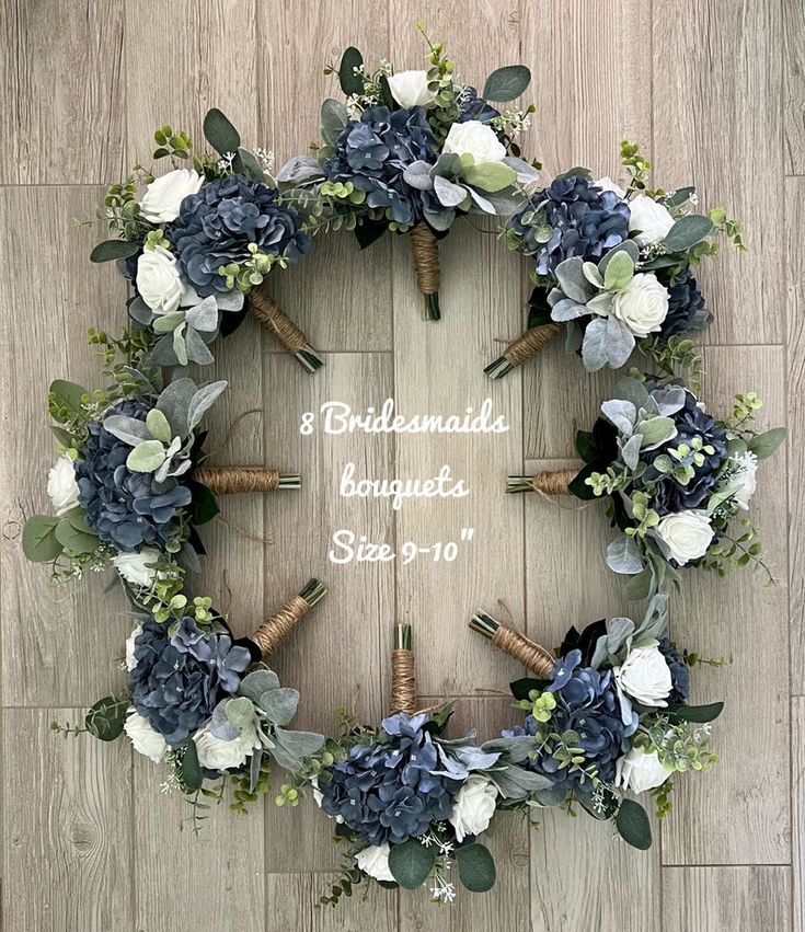 a wreath made out of blue and white flowers on a wooden floor with corks