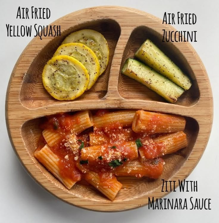 a wooden plate topped with different types of pasta and sauce on top of each other