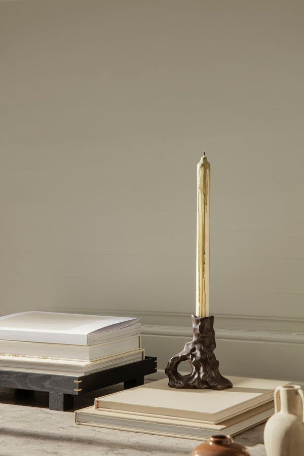 a candle and some books on a table