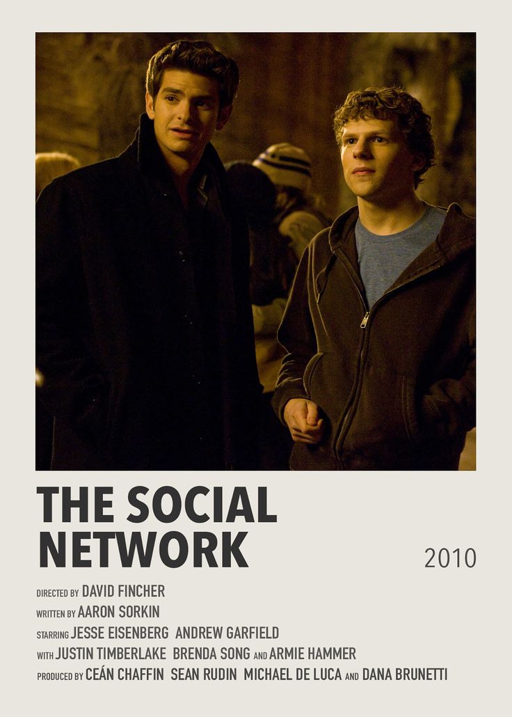 two men standing next to each other in front of a poster for the social network