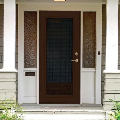 the front door of a house with brown and white trim on it's sides