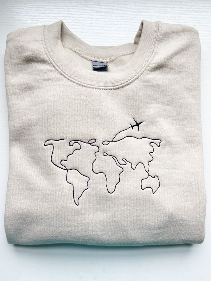 Embroidery, travel embroidery, tan sweatshirt, tan, crew, embroidery machine, world map World Map Embroidery, Embroidery Shoes Diy, Travel Embroidery, Embroidery Hoop Art Tutorial, Map Embroidery, Embroidery Map, Denim Pocket Details, Tshirt Printing Business, Hang Tags Clothing