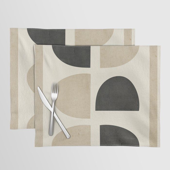 two place mats with forks and spoons on top of each one in front of an abstract design