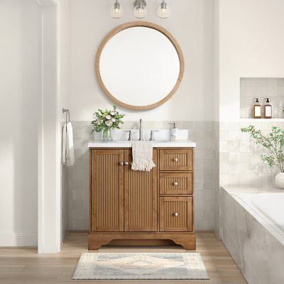 a bathroom with a sink, mirror and bathtub