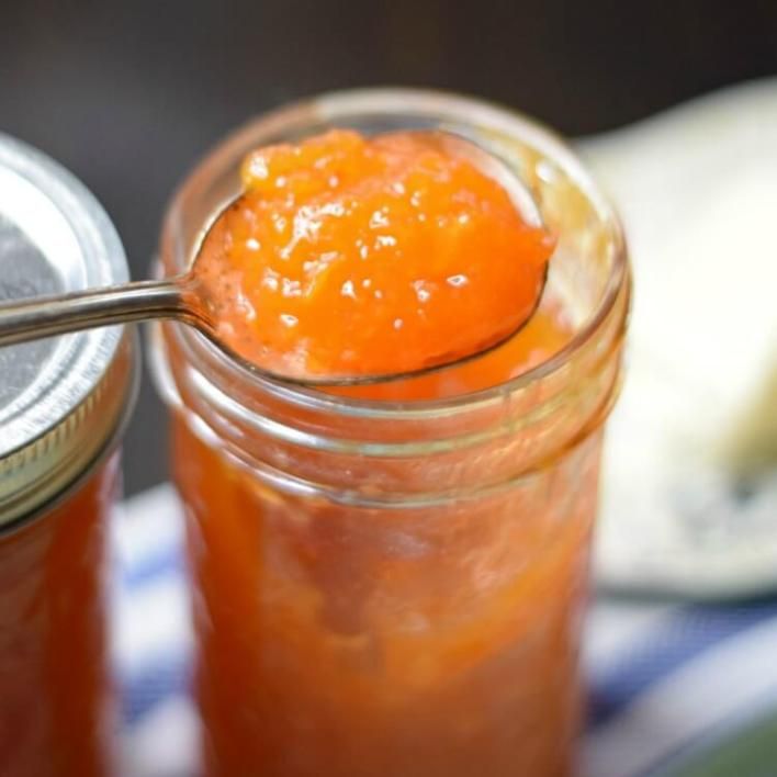 two jars filled with jam sitting on top of a table