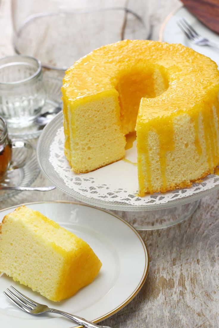 there is a cake that has been cut into pieces and served on the table with silverware