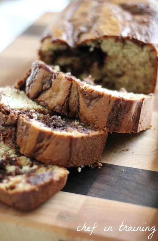 sliced loaf of banana bread sitting on top of a cutting board