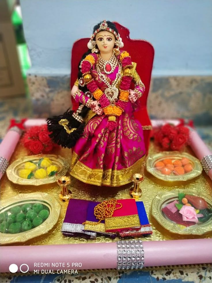 a doll is sitting on a tray with food