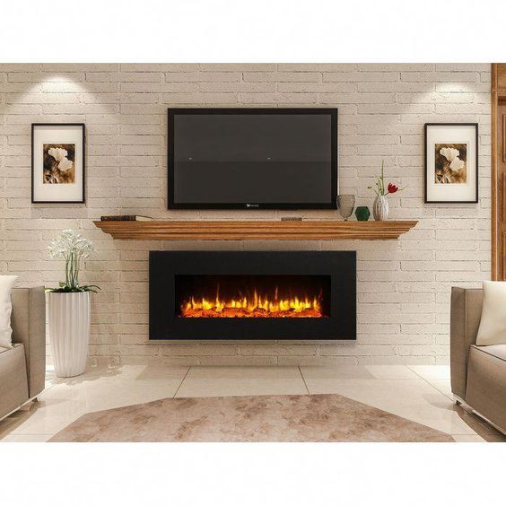 a living room with a fireplace and tv mounted on the wall above it is shown