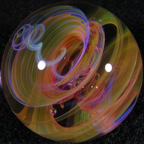 a close up of a glass ball on a black surface