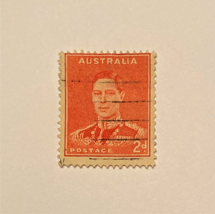 an orange stamp with the image of a man in uniform on it's side