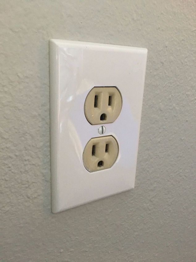 an electrical outlet with two plugs attached to it's side, in a white wall