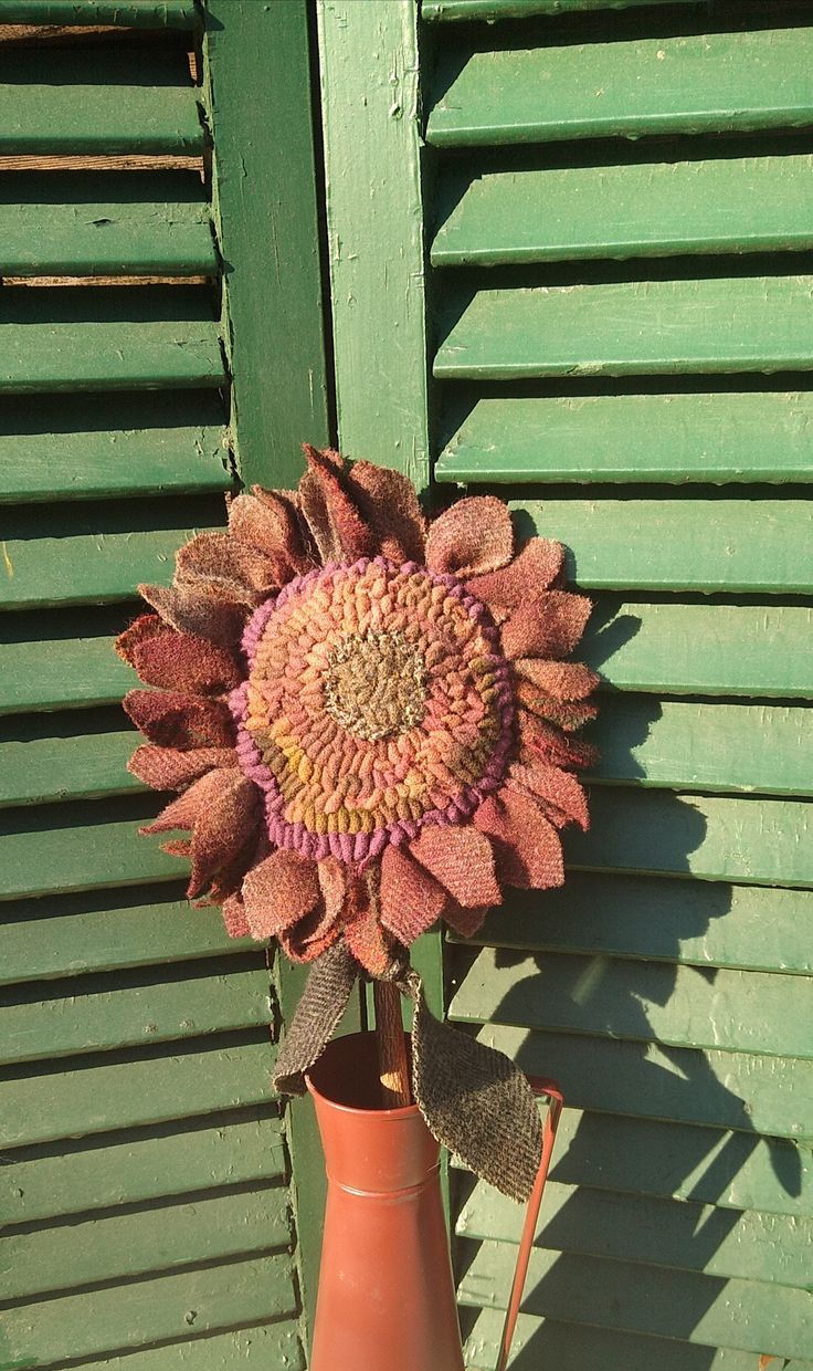 A vibrant rug hooked sunflower to enjoy all year. Each sunflower is hand hooked with wool and constructed with many steps. Each one is unique and is about 18" tall and the sunflower is 7-8" wide, with 2 wool leaves.  Perfectly primitive to display in a basket, crock or tall vase or bottle. Feel free to ask any questions. Rug Hooking Patterns Free, Rug Hooking Sunflowers, Vibrant Rug, Hit Or Miss Hooked Rugs, Primitive Pumpkin Hooked Rug, Hand Hooked Wool Rug, Antique Hooked Rug Squirrel, Hooked Rugs Primitive, Vibrant Rugs