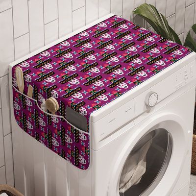 a washer and dryer sitting next to each other in front of a tiled wall