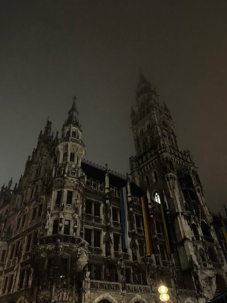 an old building with two towers at night