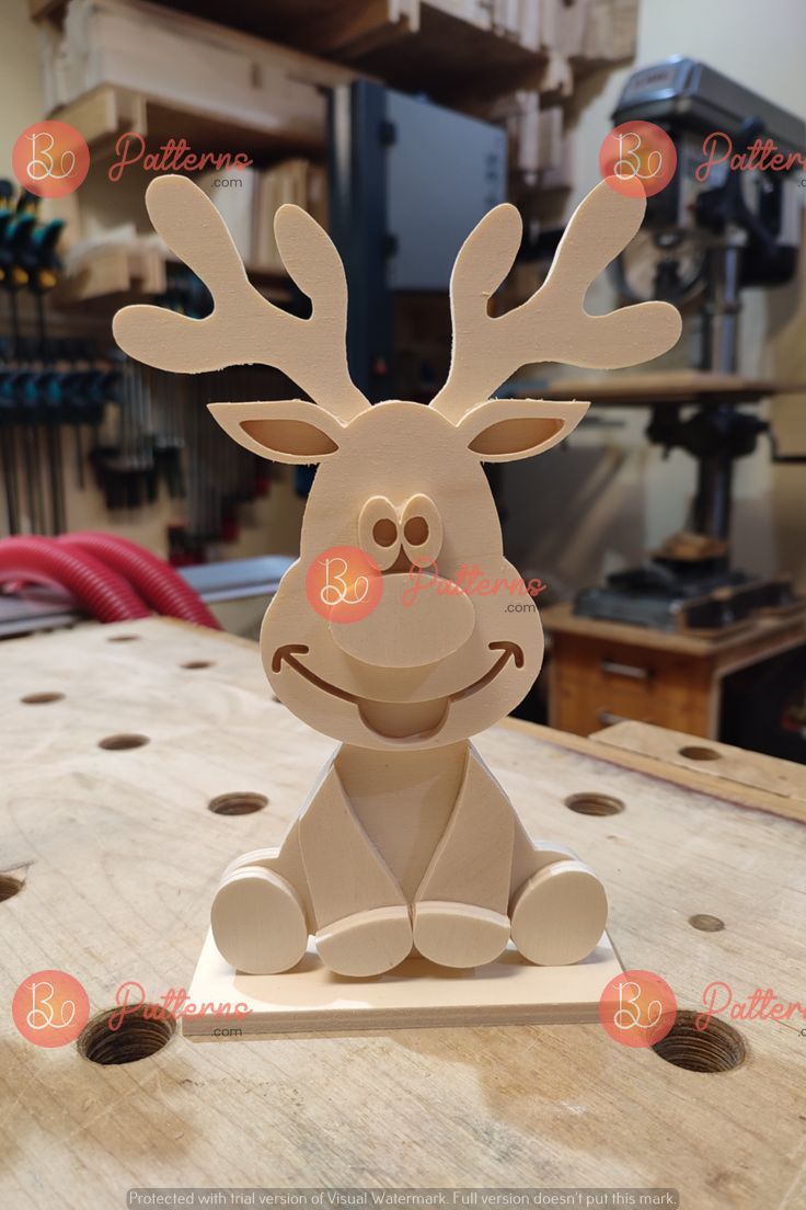 a wooden reindeer sitting on top of a table