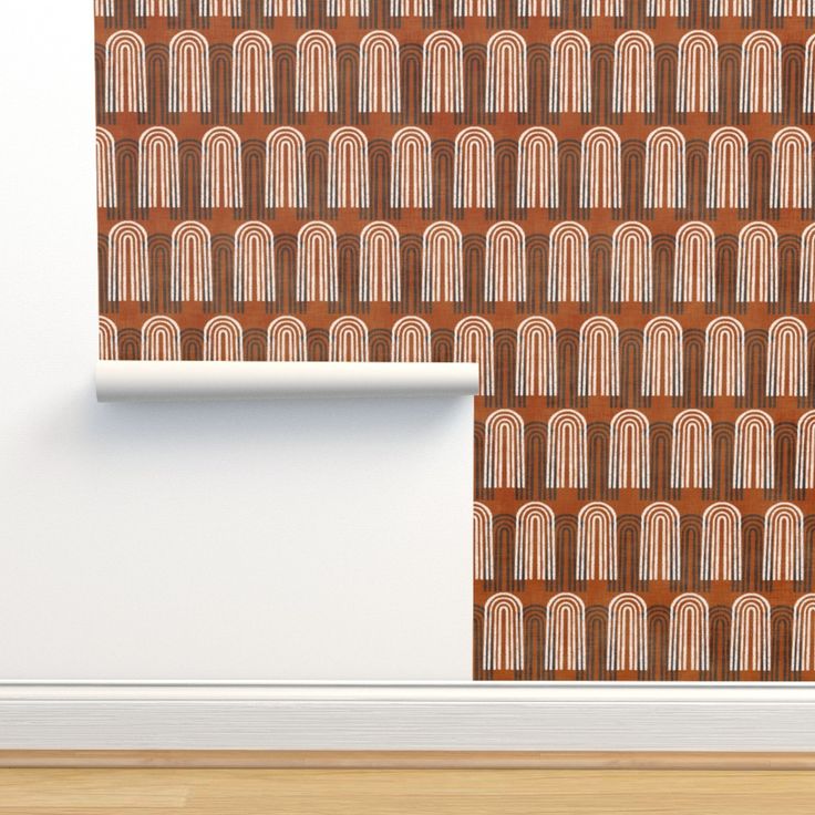 an orange and white wallpaper with arched doorways in the center on a wooden floor