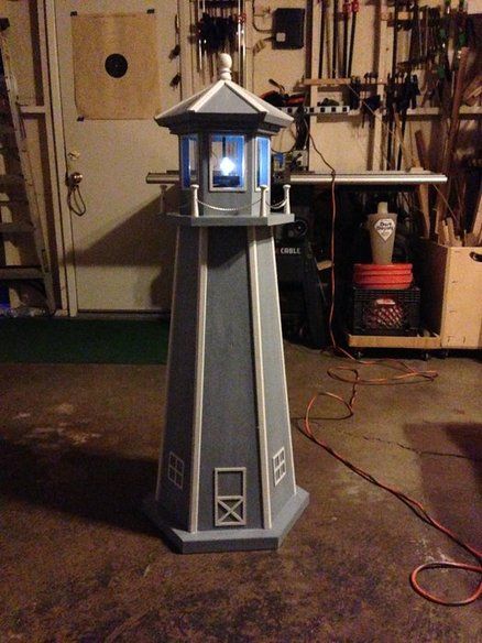 a small light tower sitting inside of a garage