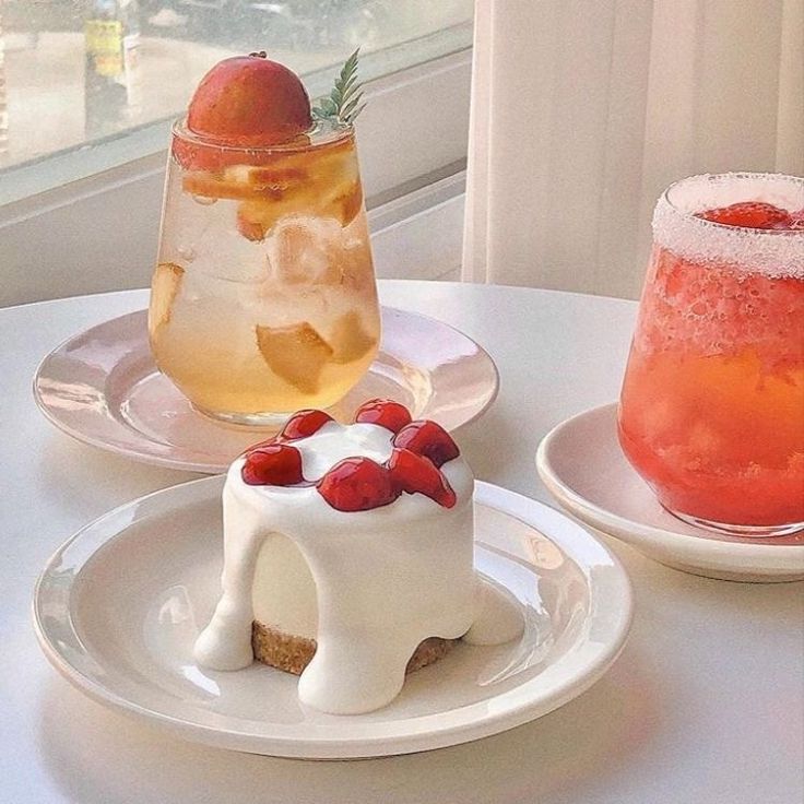 there are two desserts on the table next to each other, one with ice and strawberries