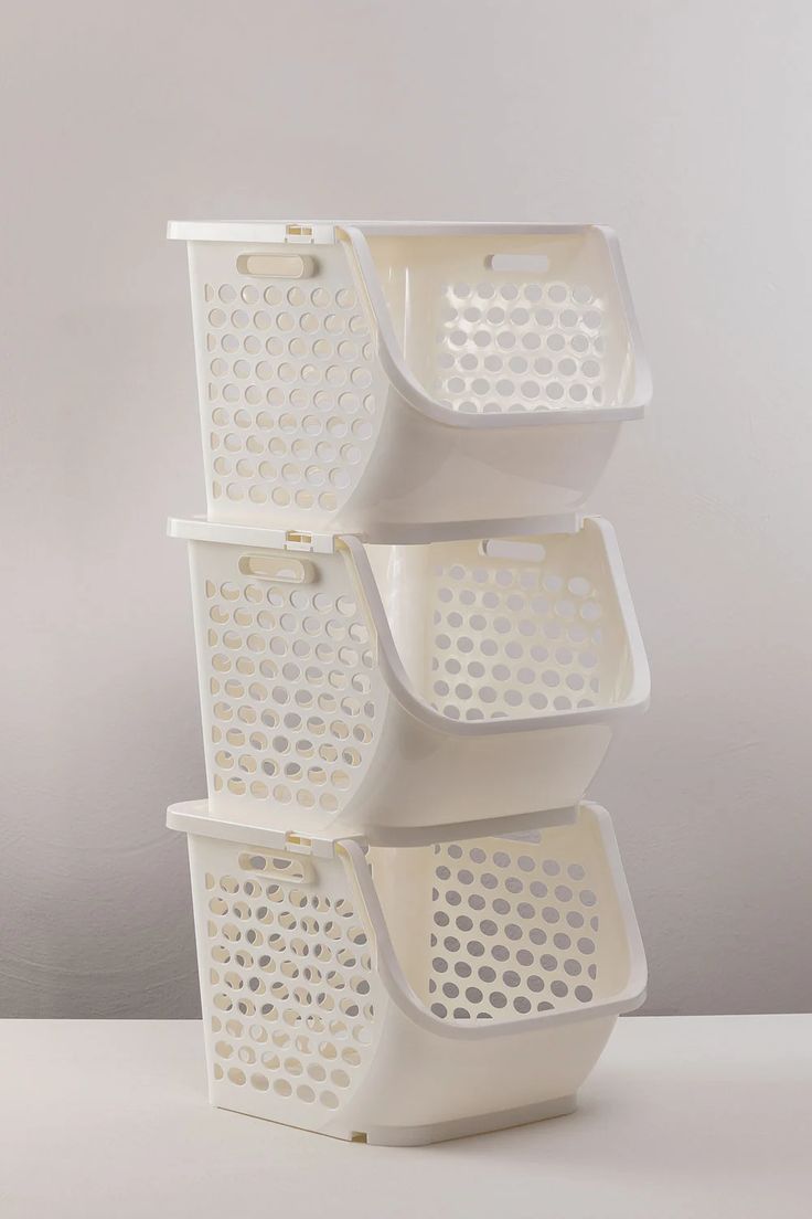 three white baskets stacked on top of each other