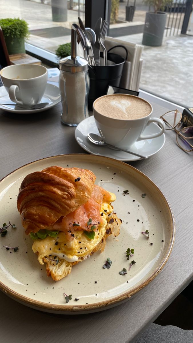 a breakfast sandwich is sitting on a plate