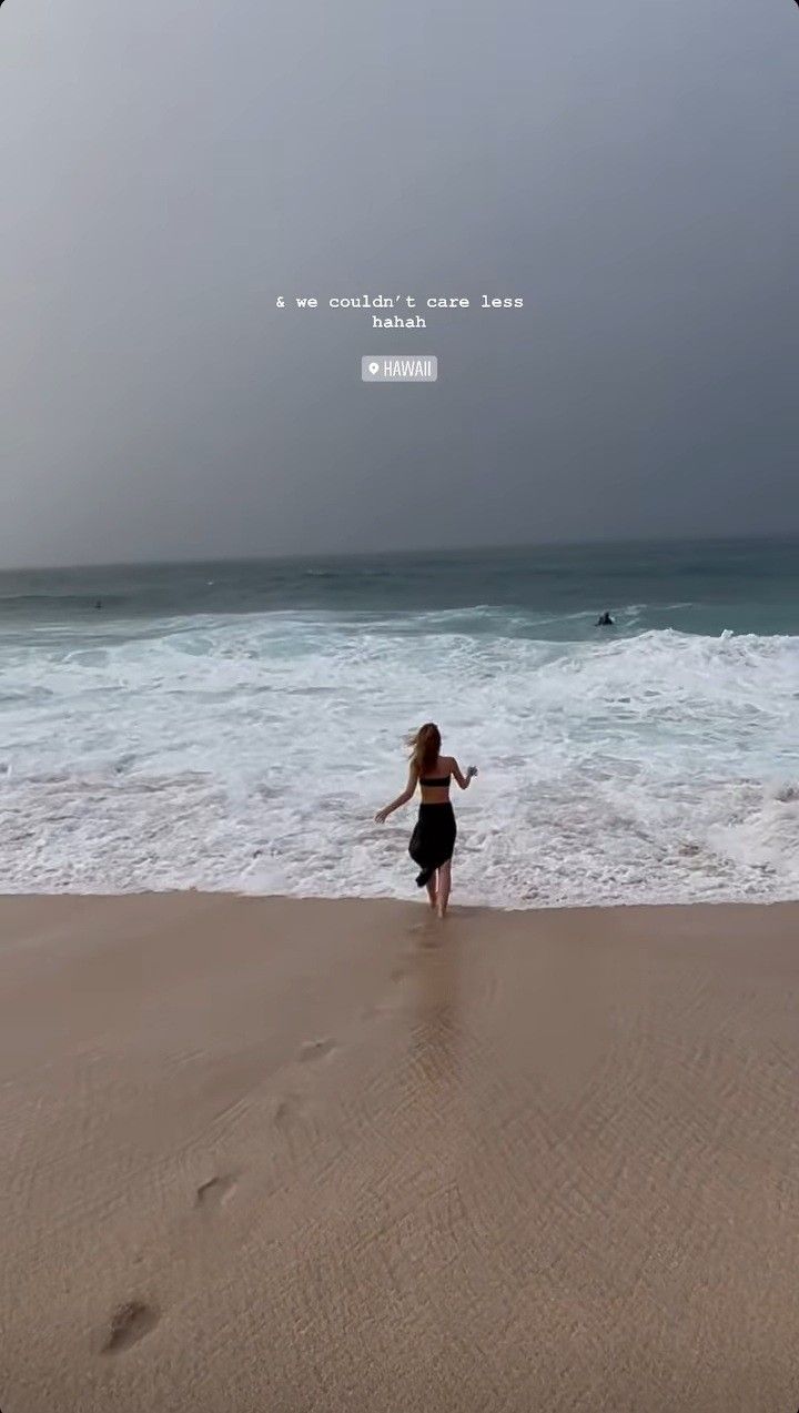 a girl running on the beach towards the ocean with an inspirational quote above her head