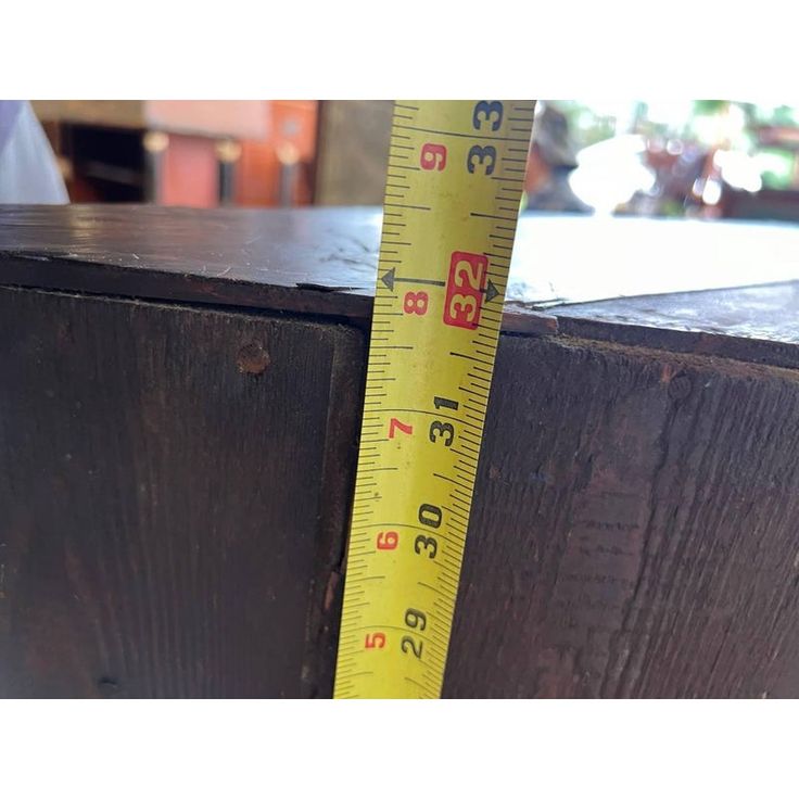 a wooden box with a measuring tape on it