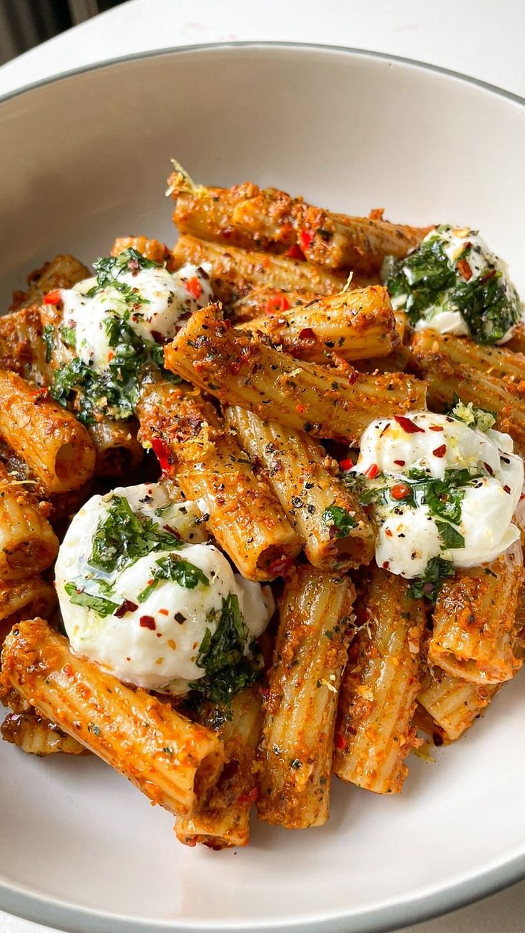 a white plate topped with pasta covered in fettuccine and parmesan cheese