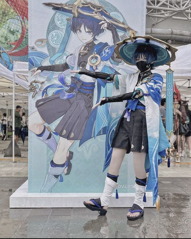 a woman dressed in costume standing next to a large sign with an anime character on it