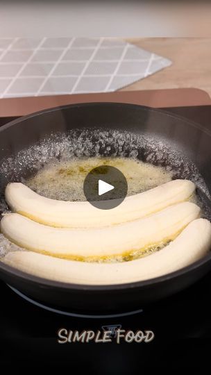 some food is cooking in a frying pan on the stove with water and oil