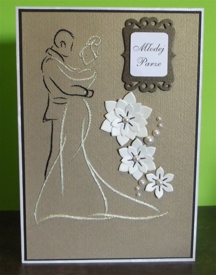 a handmade wedding card with white flowers and a bride's dress on it