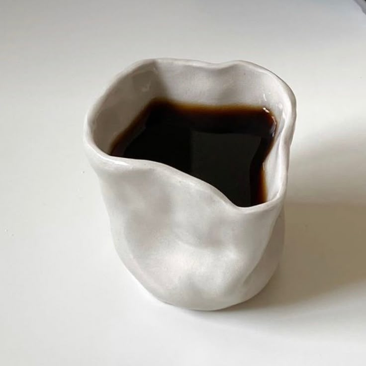 a cup filled with liquid sitting on top of a table