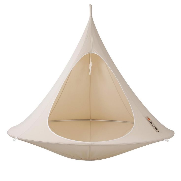 a white hanging chair with a beige cover on the top and bottom part, in front of a white background