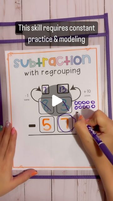 two hands are writing subtraction on a piece of paper