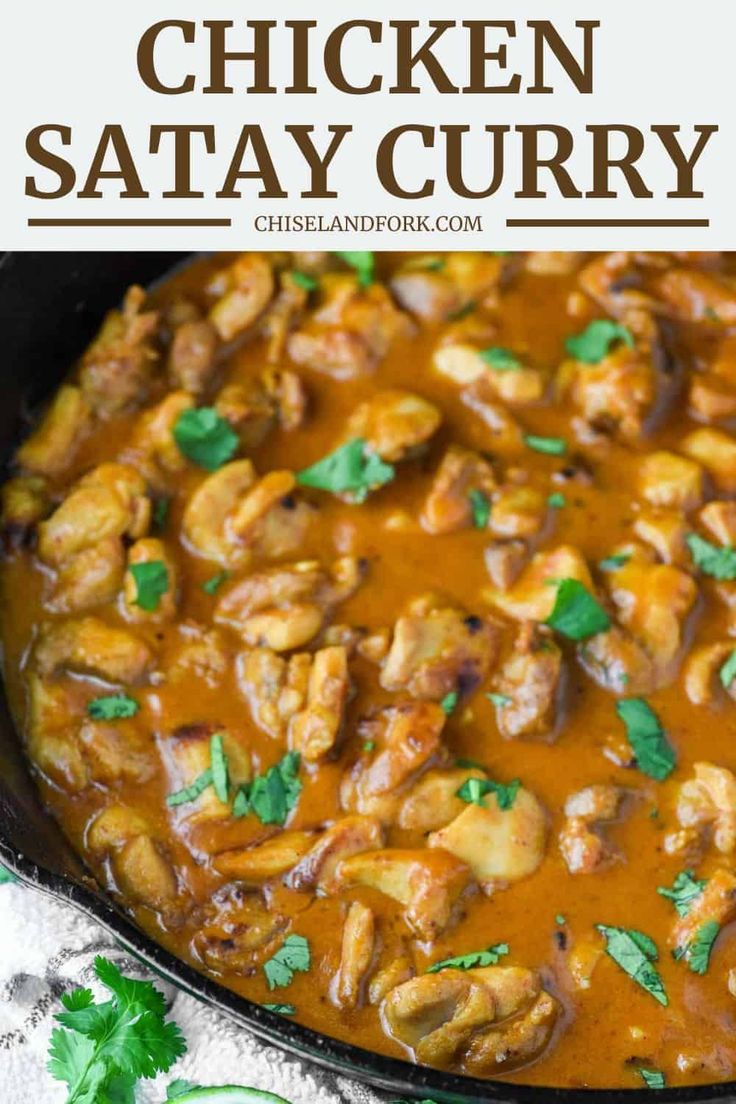 chicken satay curry in a skillet with cilantro and parsley on the side